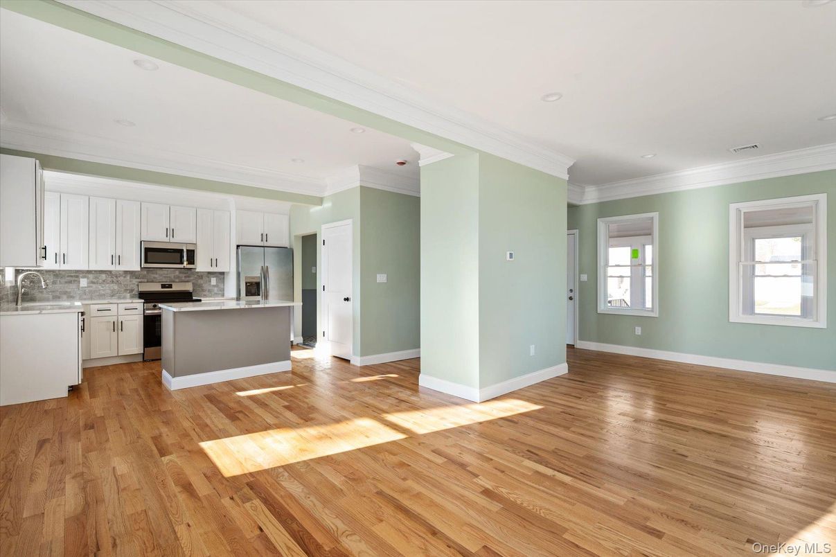 Empty room, Interior, Kitchen, Recessed Lighting, Stainless Steel Appliances, Wood Texture Flooring