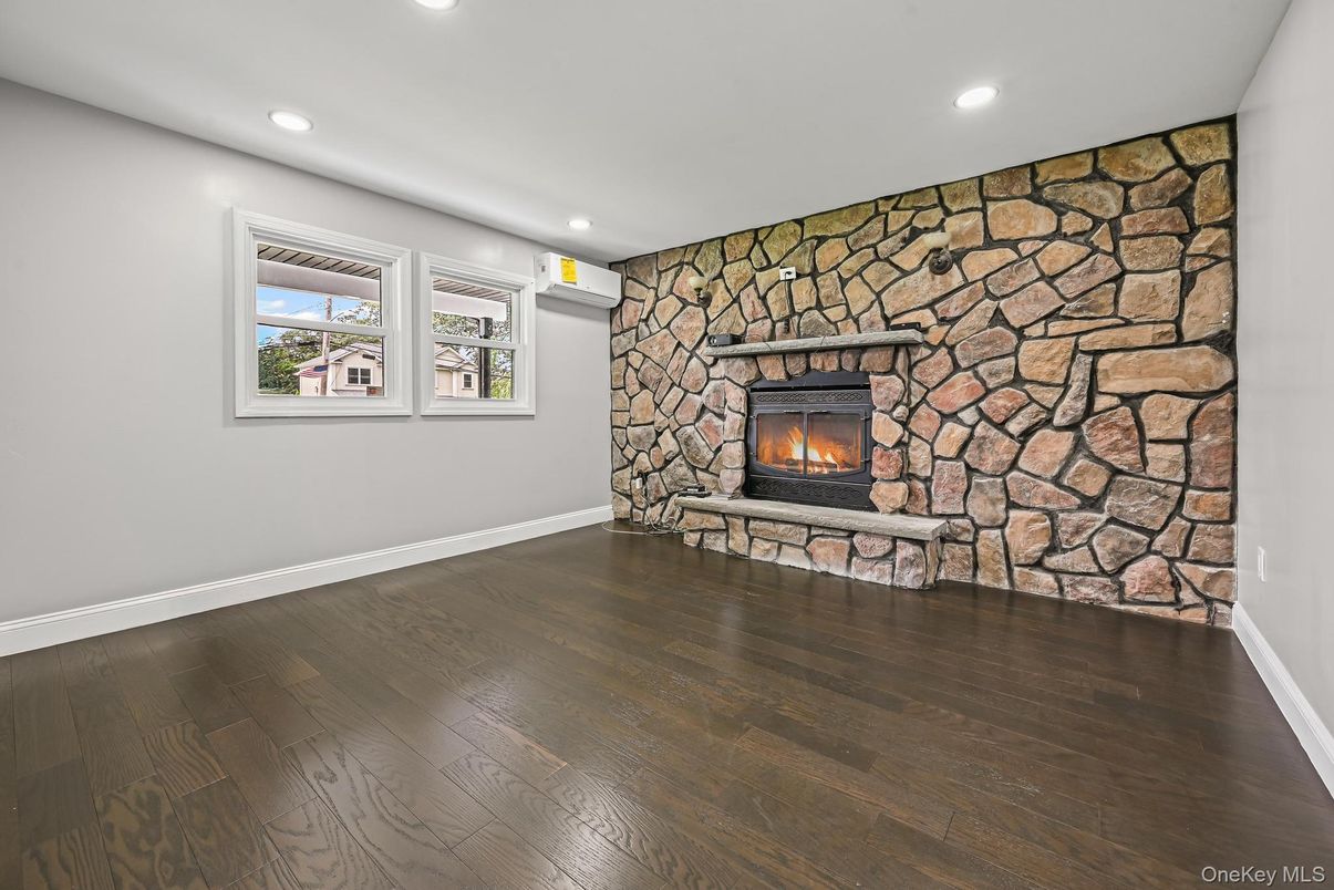 Empty room, Fireplace, Interior, Recessed Lighting, Stone Walls, Wood Texture Flooring
