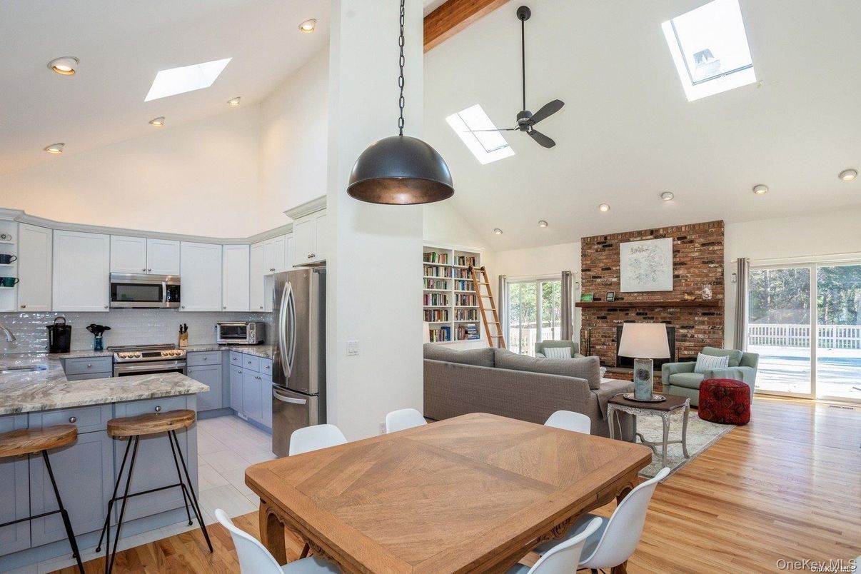 Dining room, Fireplace, Interior, Kitchen, Living room, Pendant Lights, Recessed Lighting, Stainless Steel Appliances, Stone Walls, Wood Texture Flooring