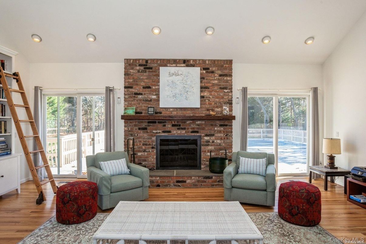 Fireplace, Interior, Living room, Recessed Lighting, Stone Walls, Wood Texture Flooring