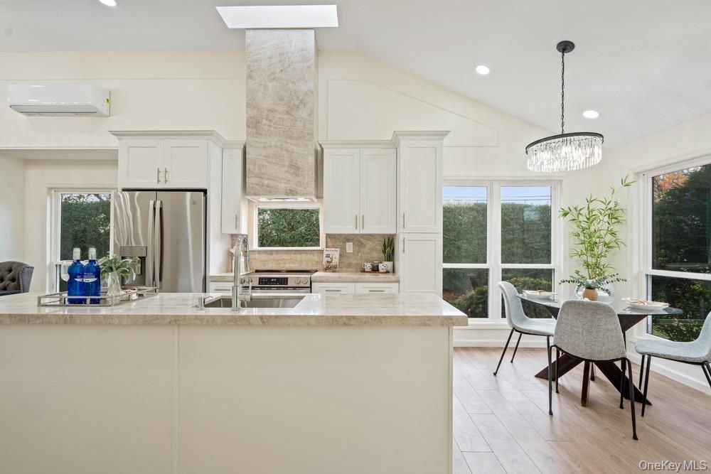 Chandelier, Dining room, Interior, Kitchen, Pendant Lights, Recessed Lighting, Stainless Steel Appliances, Wood Texture Flooring