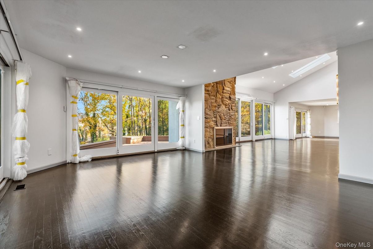 Empty room, Fireplace, Interior, Recessed Lighting, Stone Walls, Wood Texture Flooring