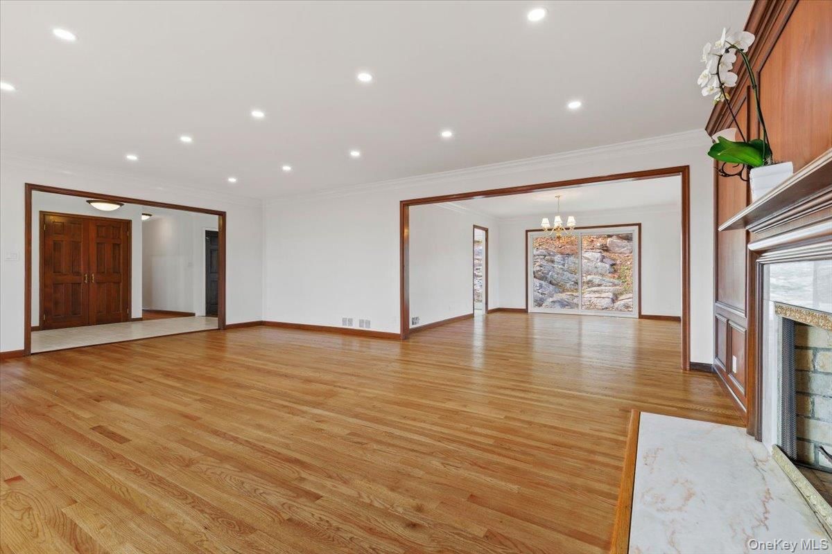 Chandelier, Empty room, Fireplace, Interior, Recessed Lighting, Wood Texture Flooring