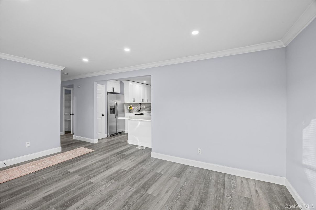Empty room, Interior, Kitchen, Recessed Lighting, Stainless Steel Appliances, Wood Texture Flooring