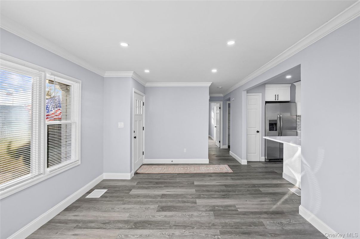 Empty room, Interior, Kitchen, Recessed Lighting, Stainless Steel Appliances, Wood Texture Flooring