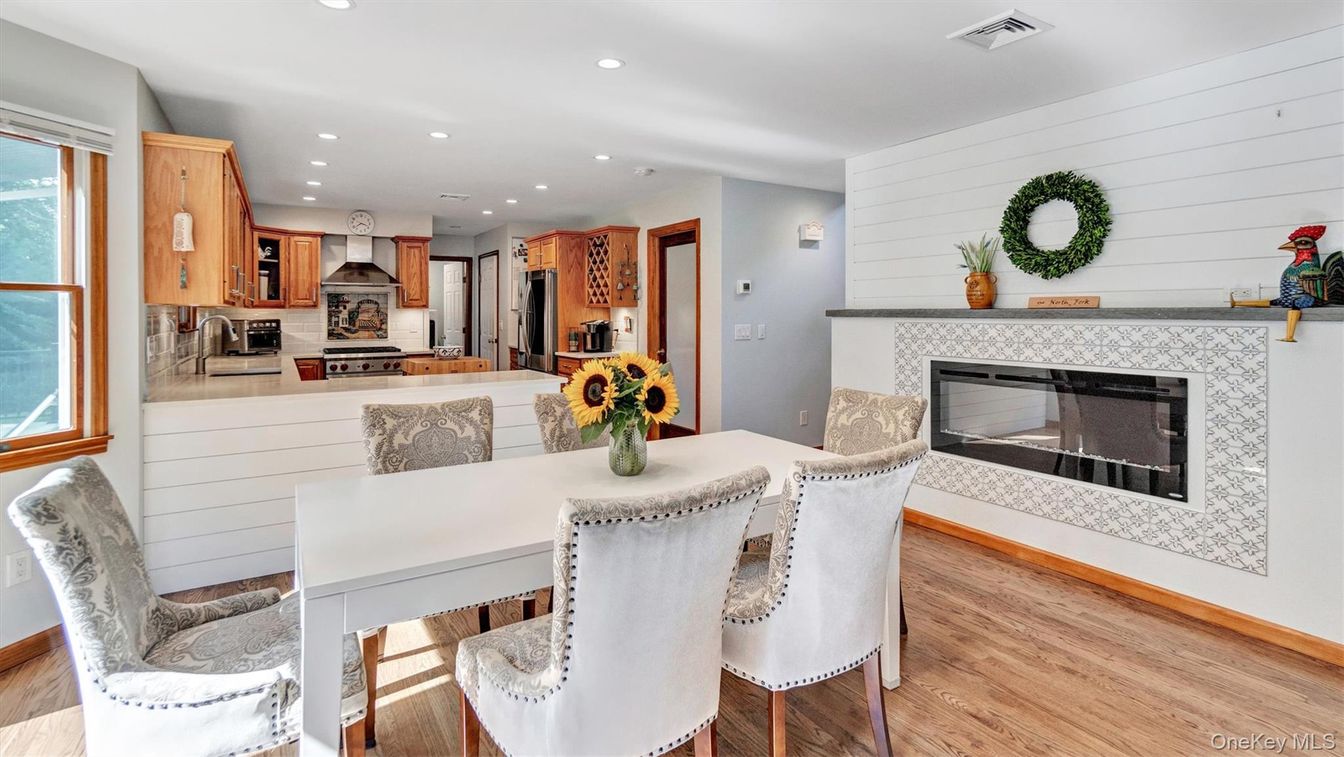 Dining room, Fireplace, Interior, Kitchen, Recessed Lighting, Stainless Steel Appliances, Wood Texture Flooring