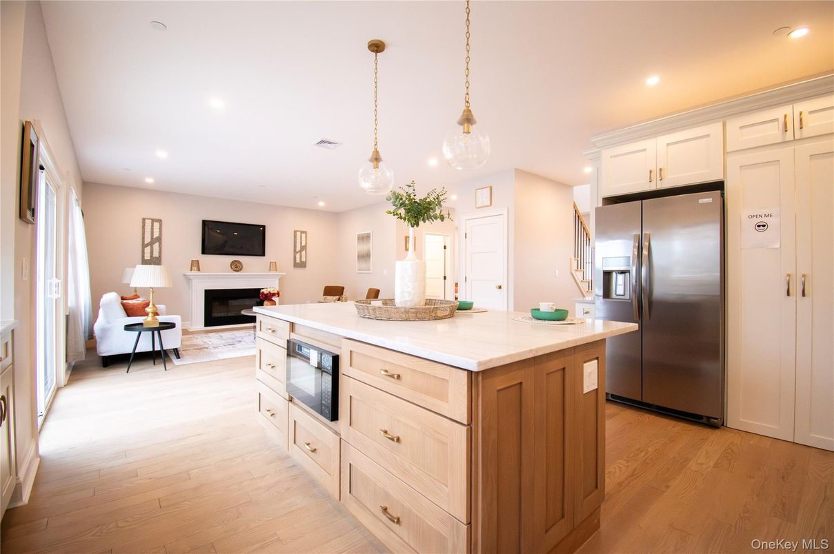 Fireplace, Interior, Kitchen, Living room, Pendant Lights, Recessed Lighting, Stainless Steel Appliances, Wood Texture Flooring