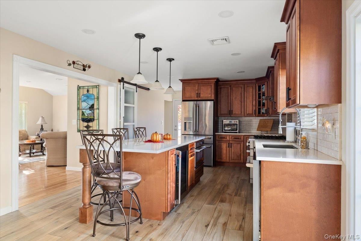 Dining room, Interior, Kitchen, Pendant Lights, Recessed Lighting, Stainless Steel Appliances, Wood Texture Flooring