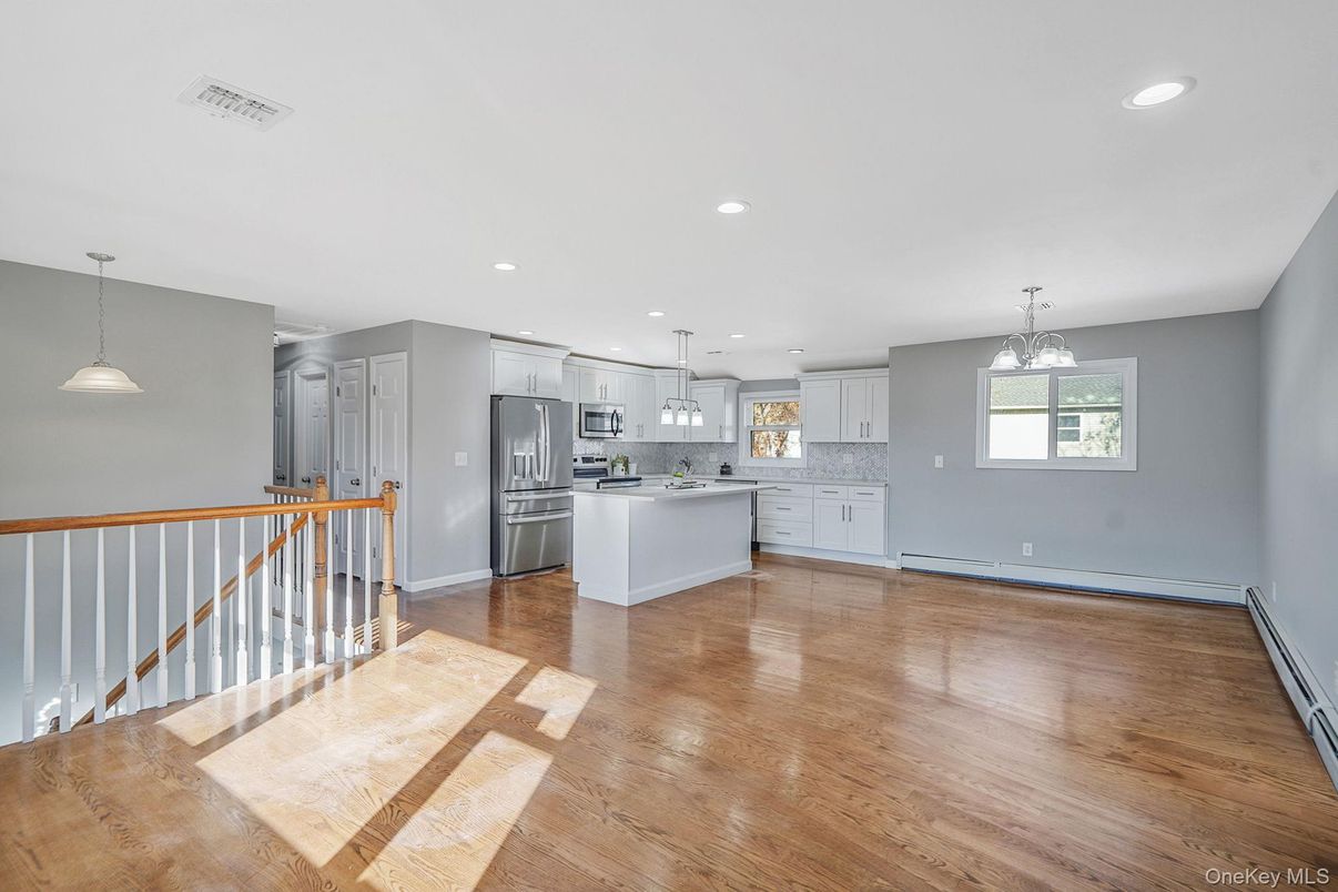 Empty room, Interior, Kitchen, Pendant Lights, Recessed Lighting, Stainless Steel Appliances, Wood Texture Flooring