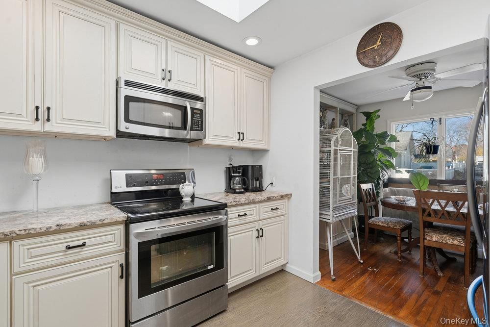 Dining room, Interior, Kitchen, Recessed Lighting, Stainless Steel Appliances, Wood Texture Flooring
