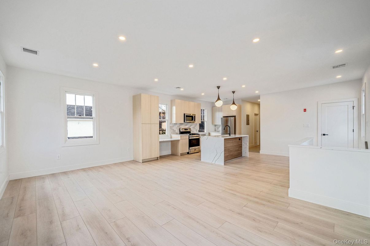 Empty room, Interior, Kitchen, Pendant Lights, Recessed Lighting, Stainless Steel Appliances, Wood Texture Flooring
