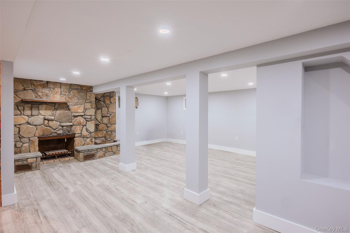 Empty room, Fireplace, Interior, Recessed Lighting, Stone Walls, Wood Texture Flooring