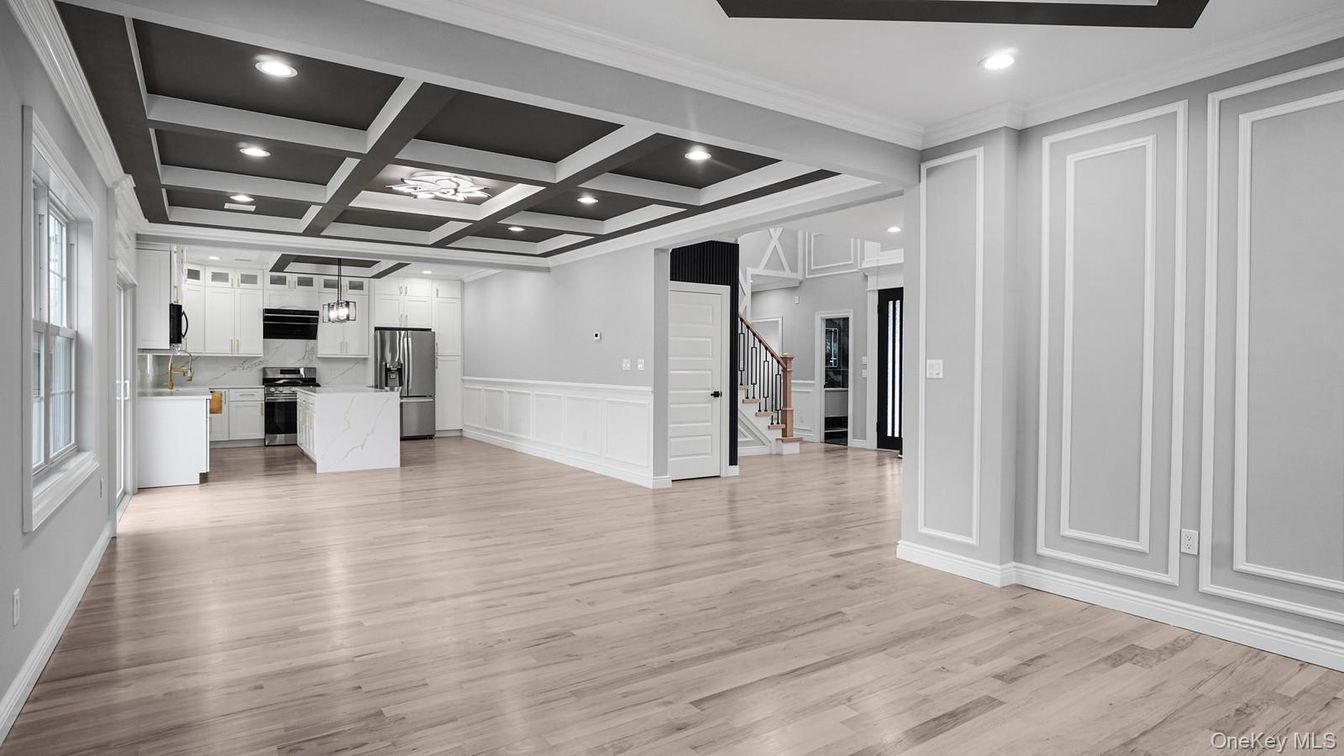 Empty room, Interior, Kitchen, Recessed Lighting, Stainless Steel Appliances, Wood Texture Flooring