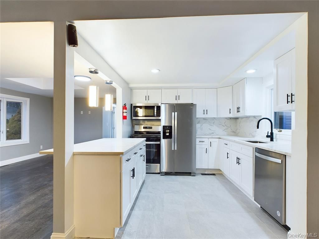 Interior, Kitchen, Marble Walls, Recessed Lighting, Stainless Steel Appliances