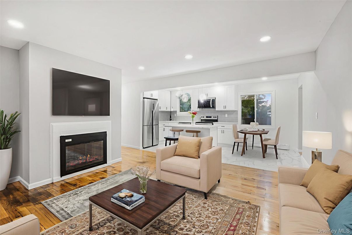 Dining room, Fireplace, Interior, Kitchen, Living room, Pendant Lights, Recessed Lighting, Stainless Steel Appliances, Wood Texture Flooring