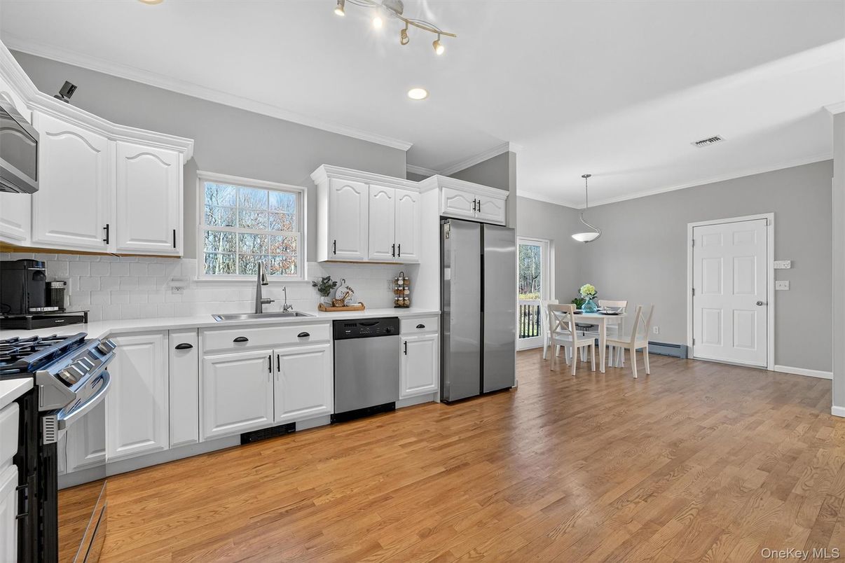 Dining room, Interior, Kitchen, Pendant Lights, Recessed Lighting, Stainless Steel Appliances, Wood Texture Flooring