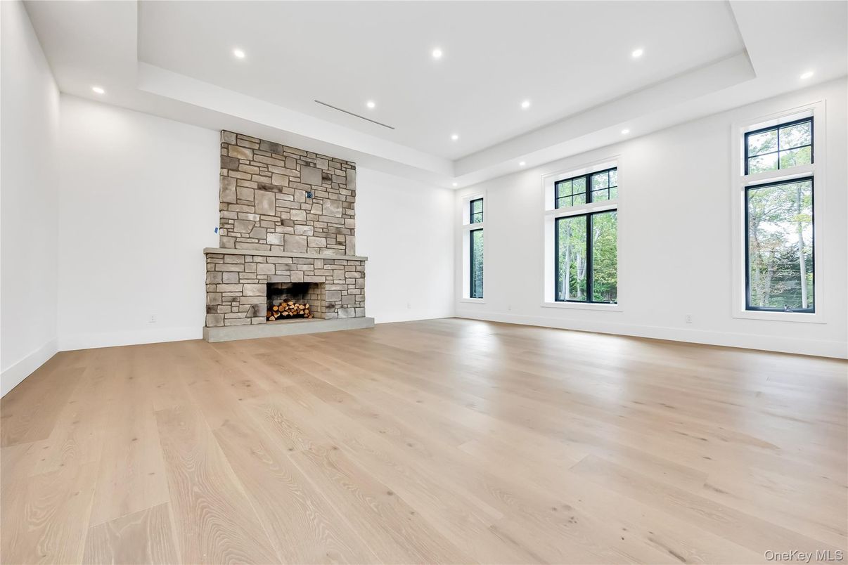 Empty room, Fireplace, Interior, Recessed Lighting, Stone Walls, Wood Texture Flooring