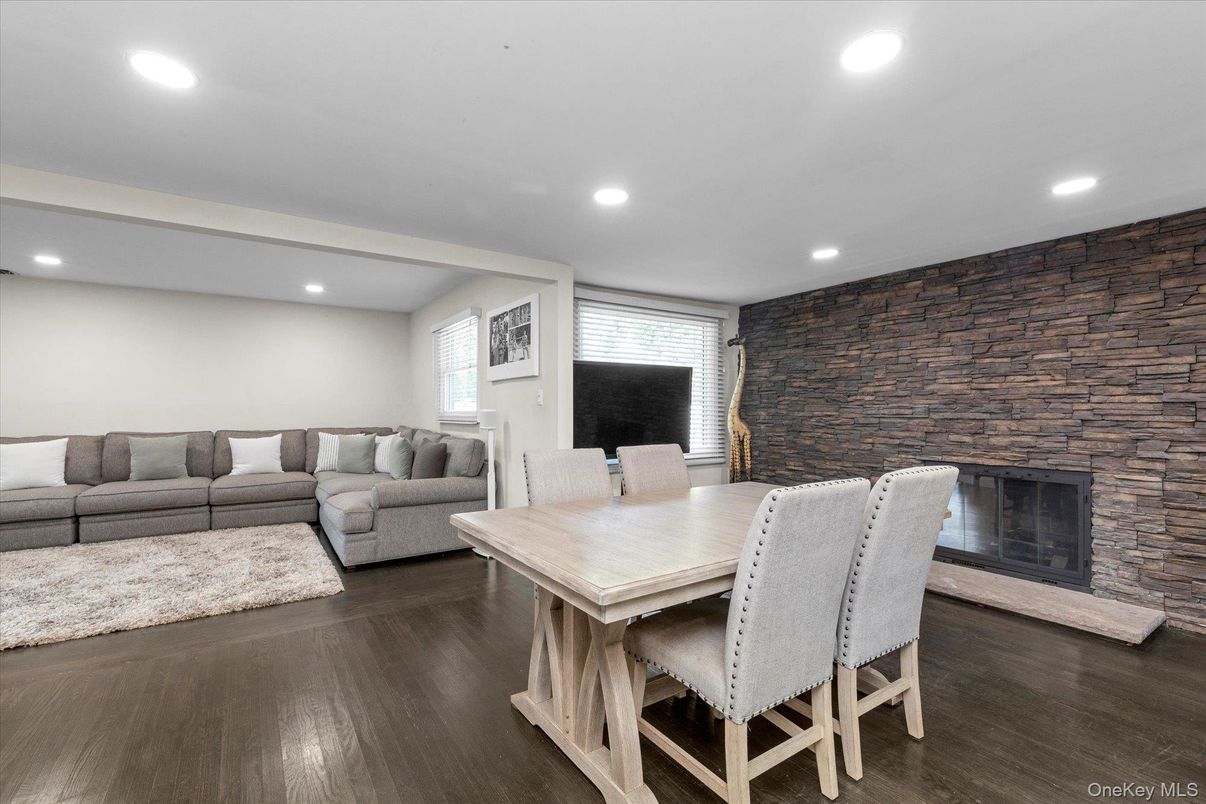 Dining room, Fireplace, Interior, Living room, Recessed Lighting, Stone Walls, Wood Texture Flooring