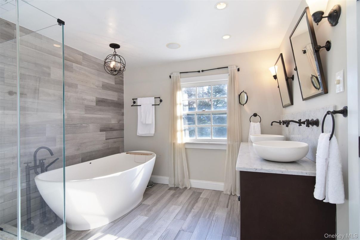 Bathroom, Dual Sink Vanities, Free Standing Baths, Glass Shower, Interior, Pendant Lights, Recessed Lighting, Wood Texture Flooring