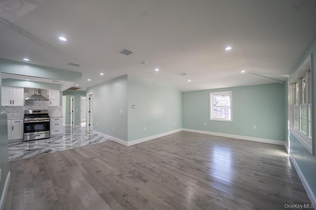 Empty room, Interior, Kitchen, Recessed Lighting, Stainless Steel Appliances, Wood Texture Flooring
