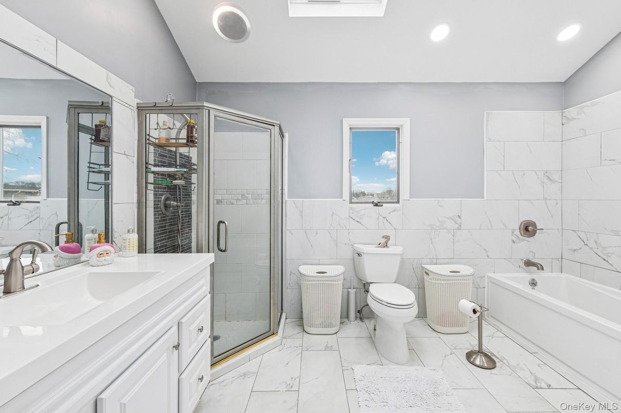 Bathroom, Dual Sink Vanities, Glass Shower, Interior, Marble, Marble Walls, Recessed Lighting