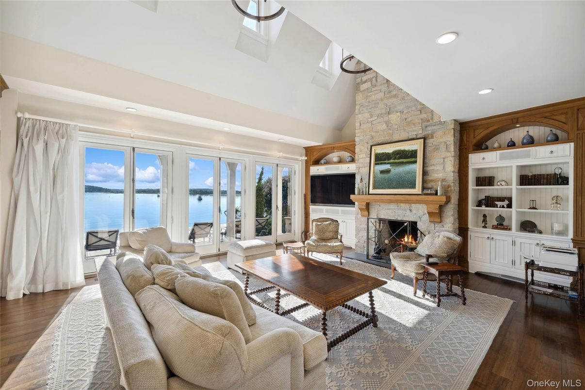 Fireplace, Interior, Living room, Recessed Lighting, Stone Walls, Water, Wood Texture Flooring