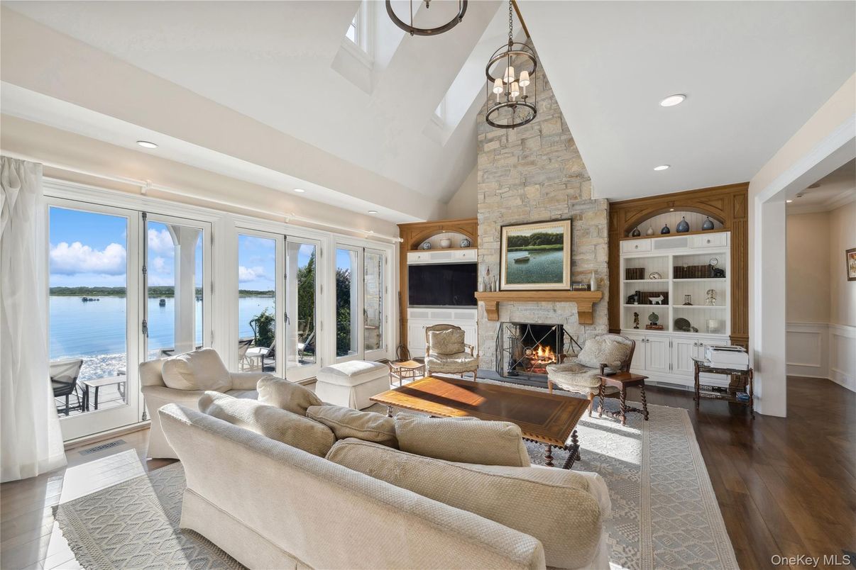 Fireplace, Interior, Living room, Recessed Lighting, Stone Walls, Water, Wood Texture Flooring