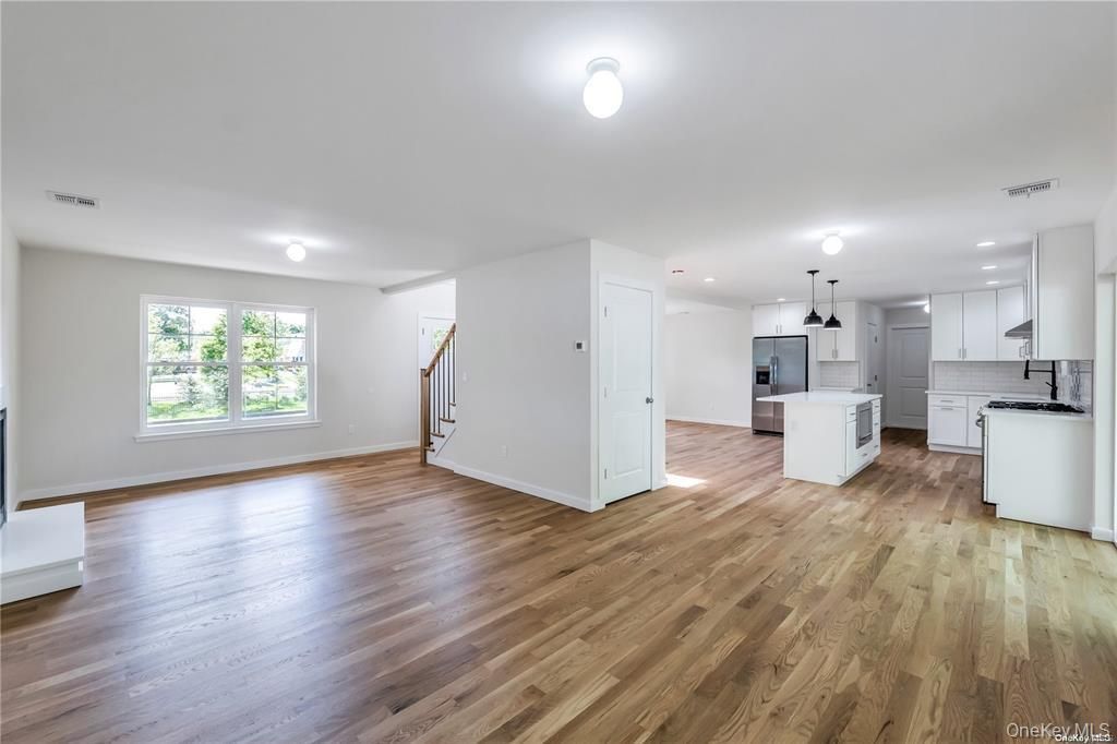 Empty room, Interior, Kitchen, Pendant Lights, Recessed Lighting, Stainless Steel Appliances, Wood Texture Flooring