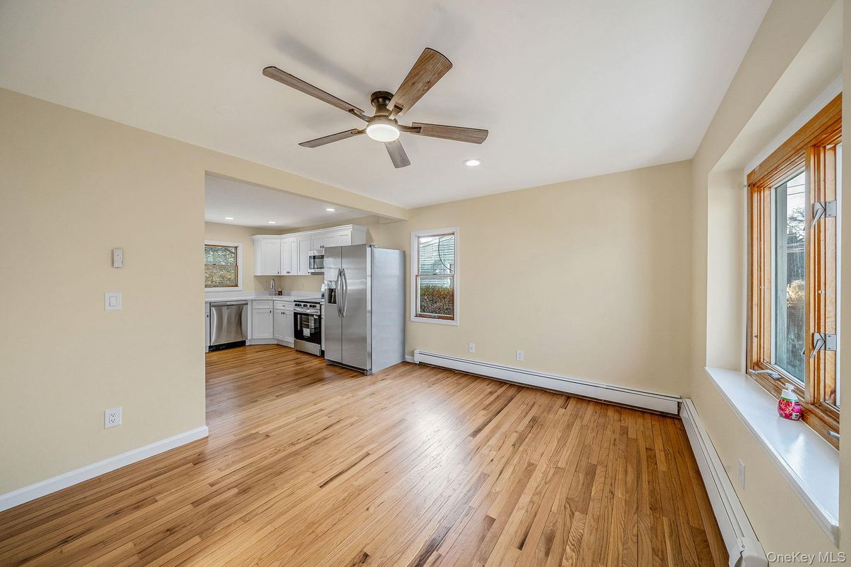 Empty room, Interior, Kitchen, Recessed Lighting, Stainless Steel Appliances, Wood Texture Flooring
