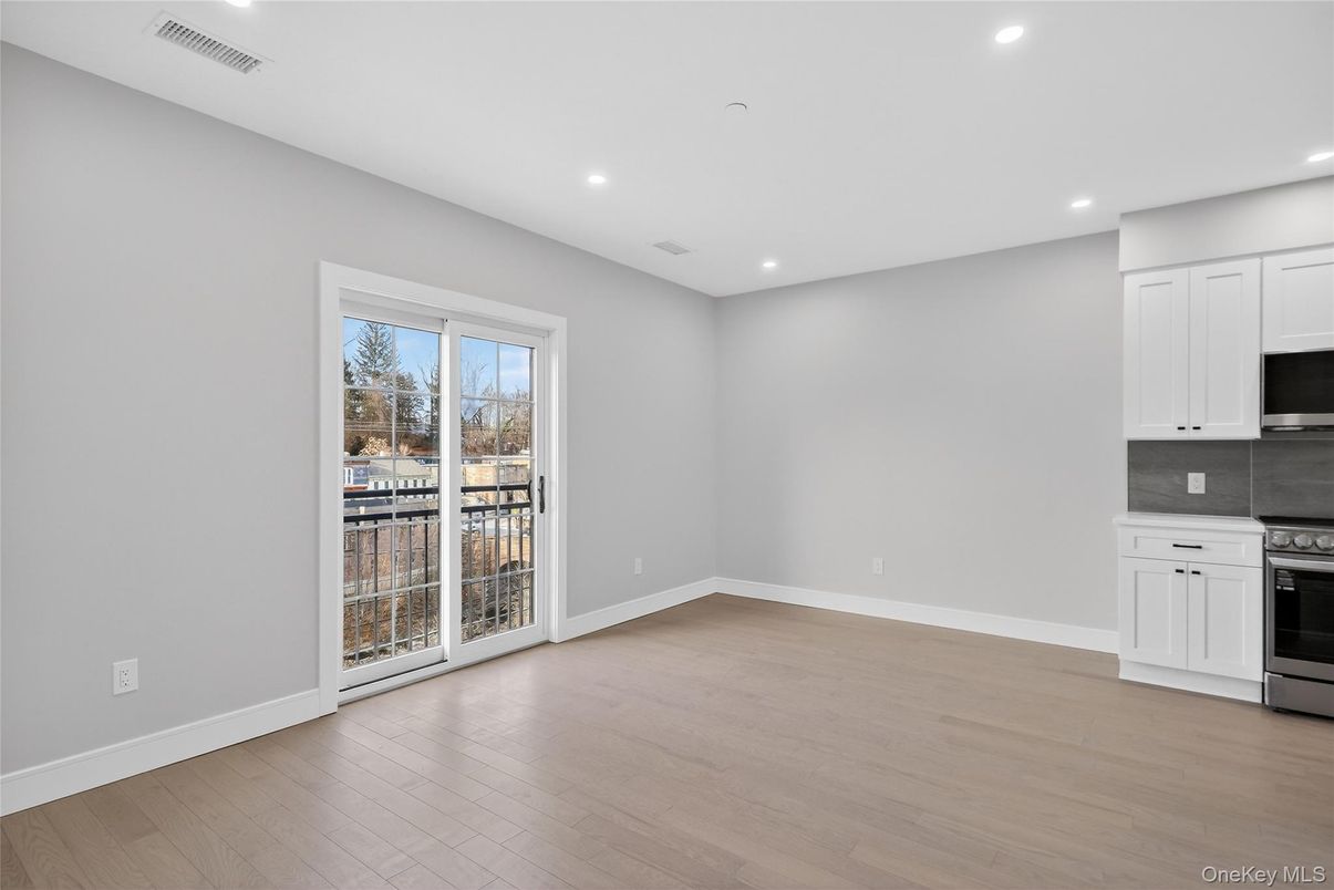 Empty room, Interior, Kitchen, Recessed Lighting, Stainless Steel Appliances, Wood Texture Flooring