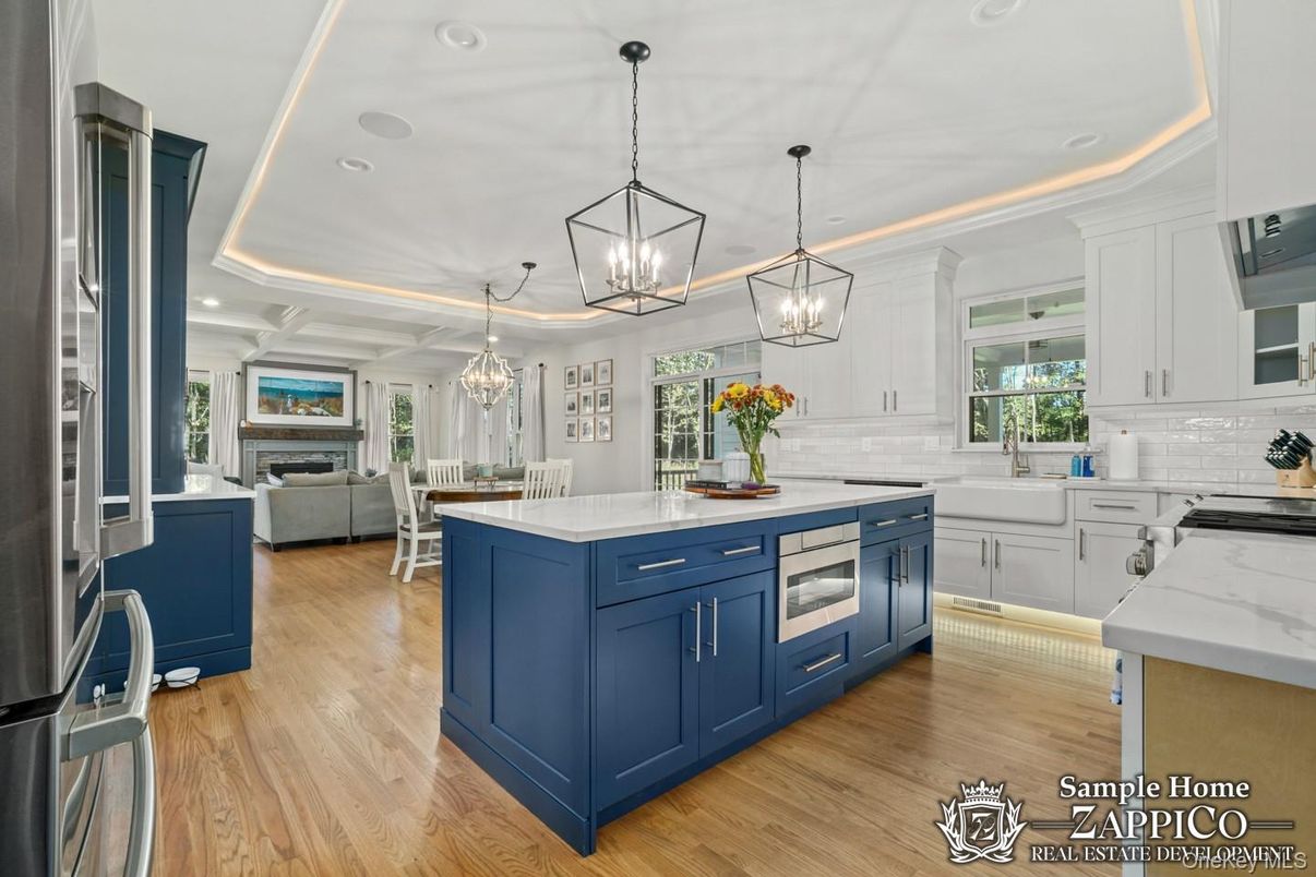 Chandelier, Dining room, Fireplace, Interior, Kitchen, Living room, Pendant Lights, Recessed Lighting, Stainless Steel Appliances, Wood Texture Flooring