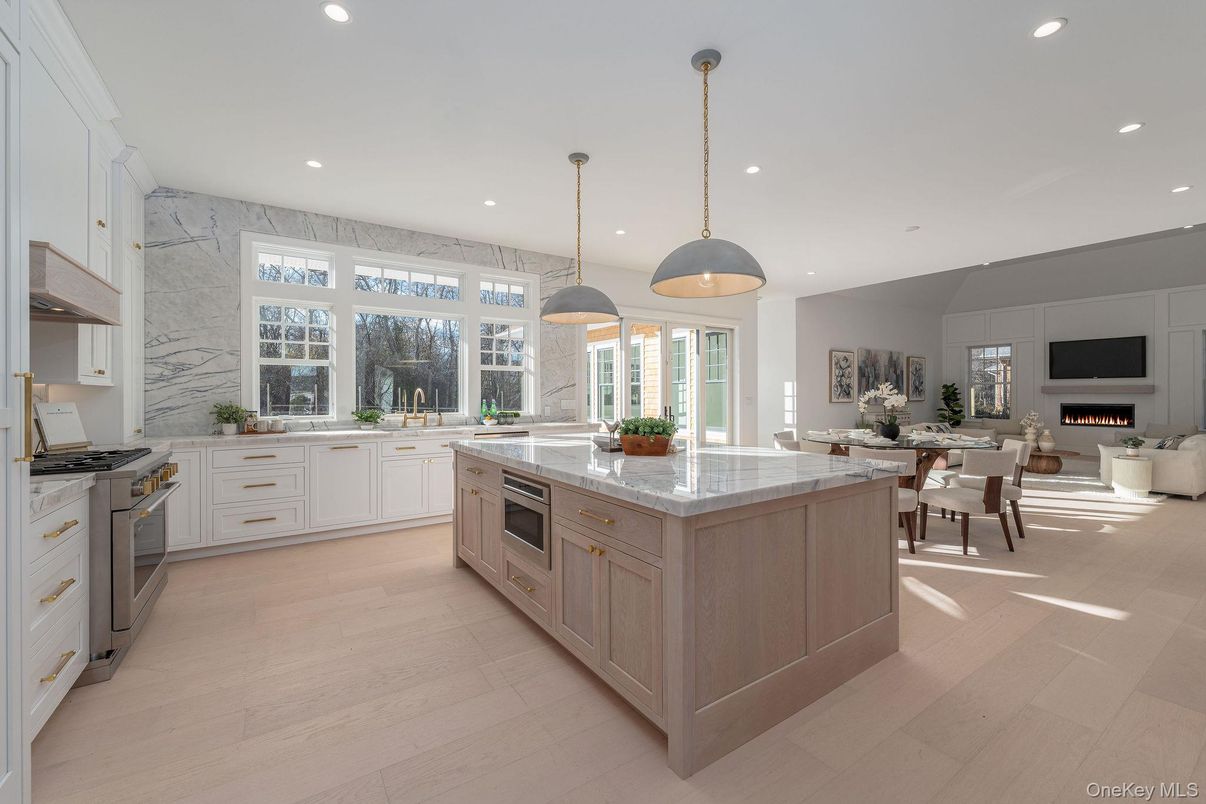 Dining room, Fireplace, Interior, Kitchen, Living room, Marble Walls, Pendant Lights, Recessed Lighting, Stainless Steel Appliances, Wood Texture Flooring