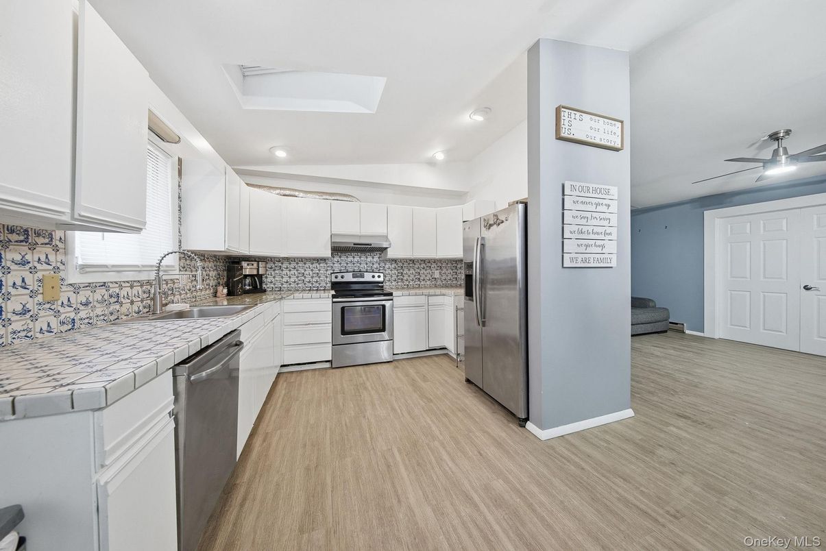 Interior, Kitchen, Recessed Lighting, Stainless Steel Appliances, Tile Countertops, Wood Texture Flooring