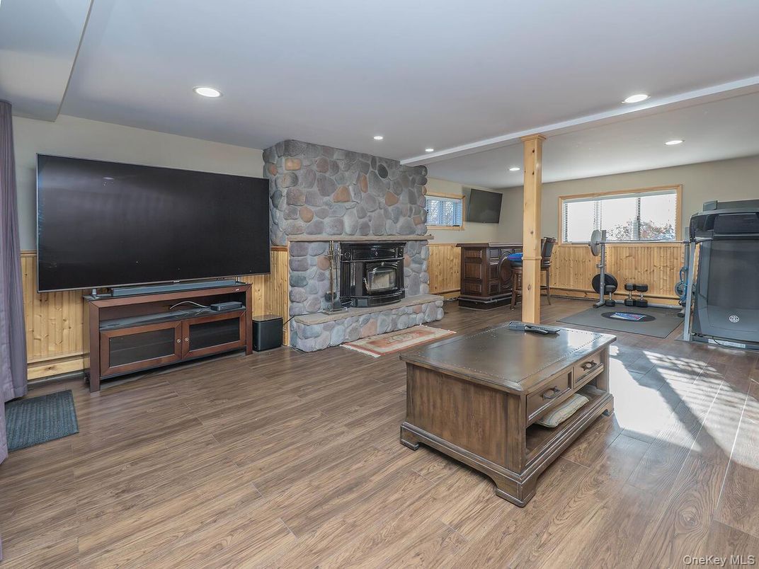 Fireplace, Fitness Equipment, Interior, Recessed Lighting, Stone Walls, Wood Texture Flooring