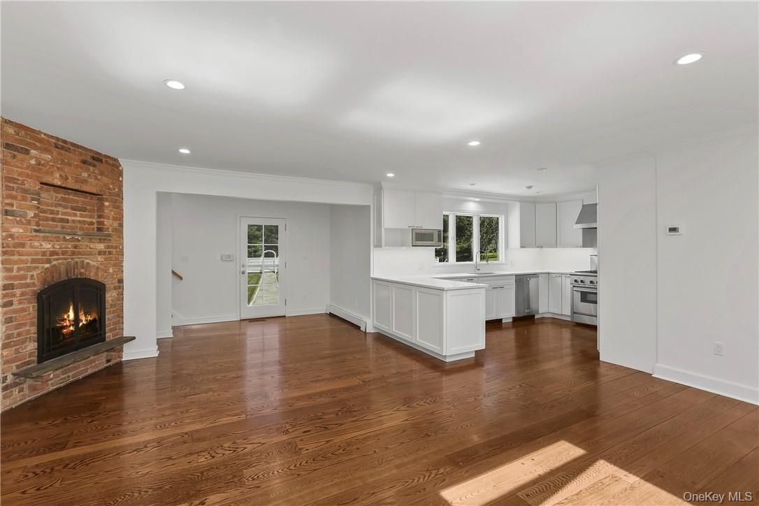 Empty room, Fireplace, Interior, Kitchen, Recessed Lighting, Stone Walls, Wood Texture Flooring
