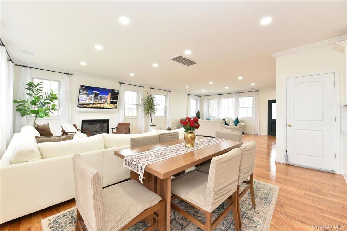 Dining room, Fireplace, Interior, Living room, Recessed Lighting, Wood Texture Flooring