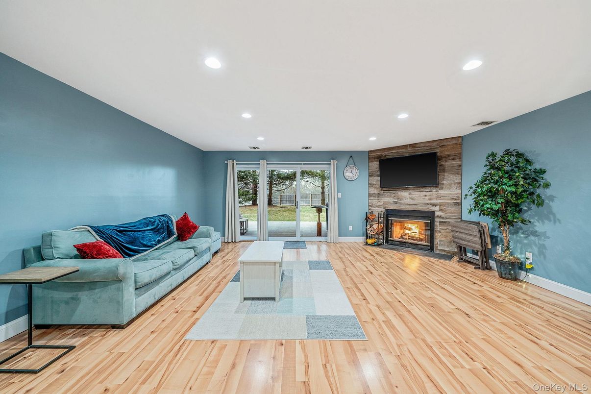 Fireplace, Interior, Living room, Recessed Lighting, Stone Walls, Wood Texture Flooring