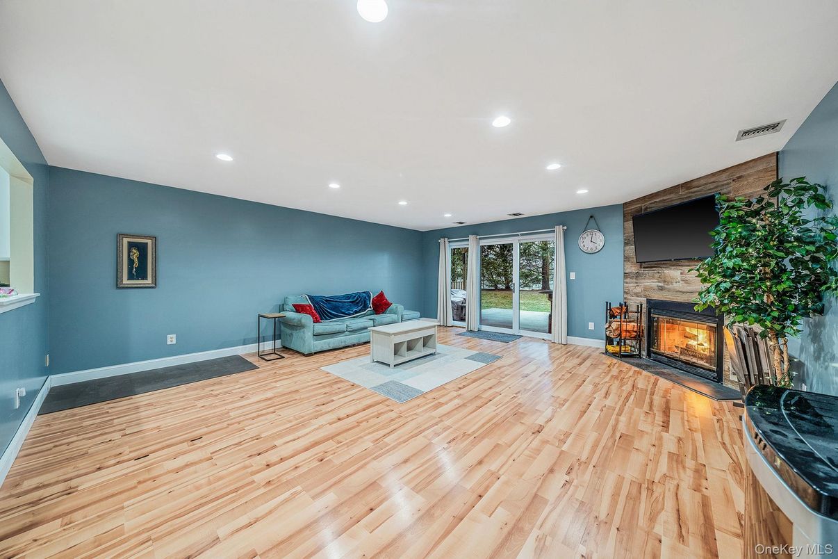 Fireplace, Interior, Living room, Recessed Lighting, Stone Walls, Wood Texture Flooring