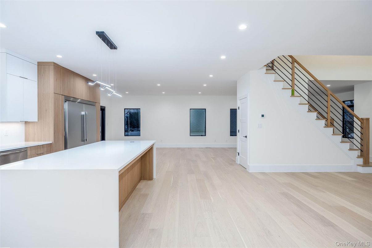 Empty room, Interior, Kitchen, Pendant Lights, Recessed Lighting, Stainless Steel Appliances, Wood Texture Flooring