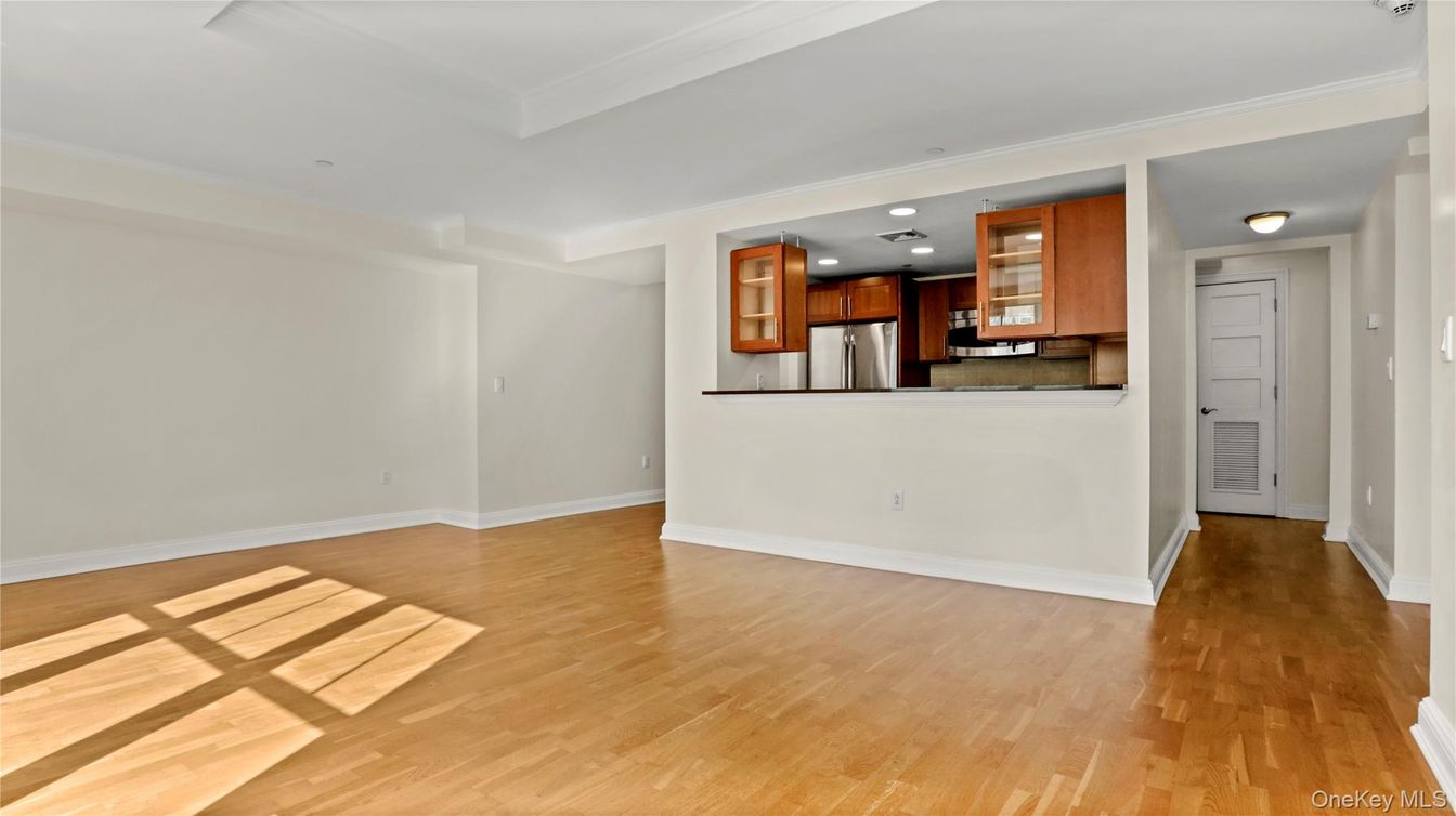 Empty room, Interior, Kitchen, Recessed Lighting, Stainless Steel Appliances, Wood Texture Flooring