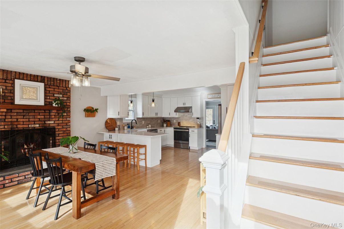 Dining room, Fireplace, Interior, Kitchen, Pendant Lights, Stainless Steel Appliances, Stone Walls, Wood Texture Flooring