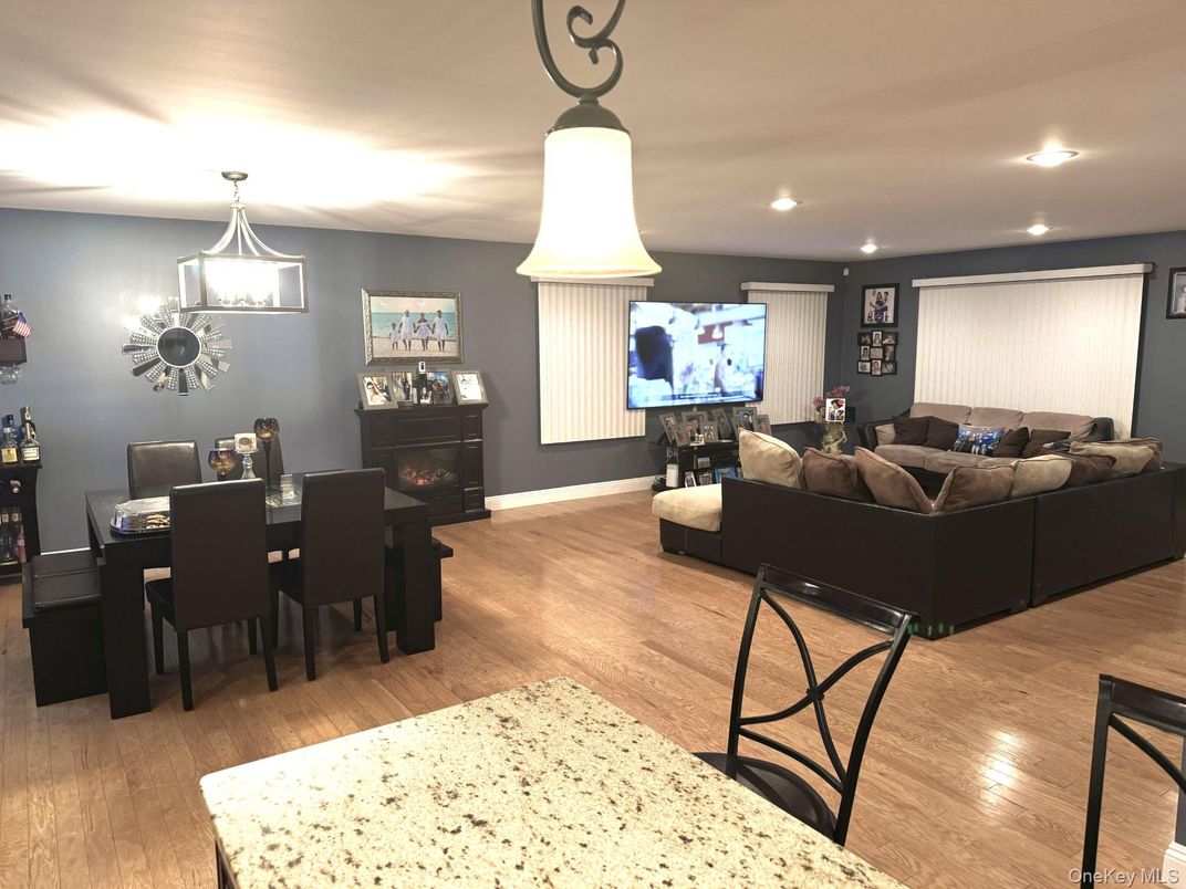 Dining room, Fireplace, Interior, Living room, Pendant Lights, Recessed Lighting, Wood Texture Flooring