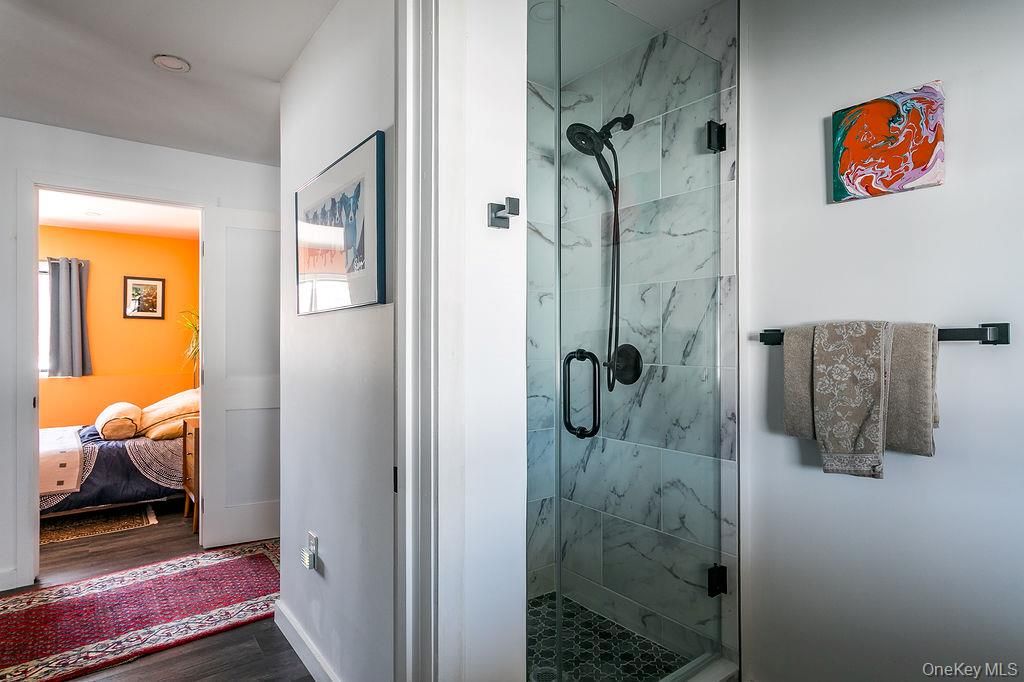 Bathroom, Glass Shower, Interior, Marble Walls, Wood Texture Flooring