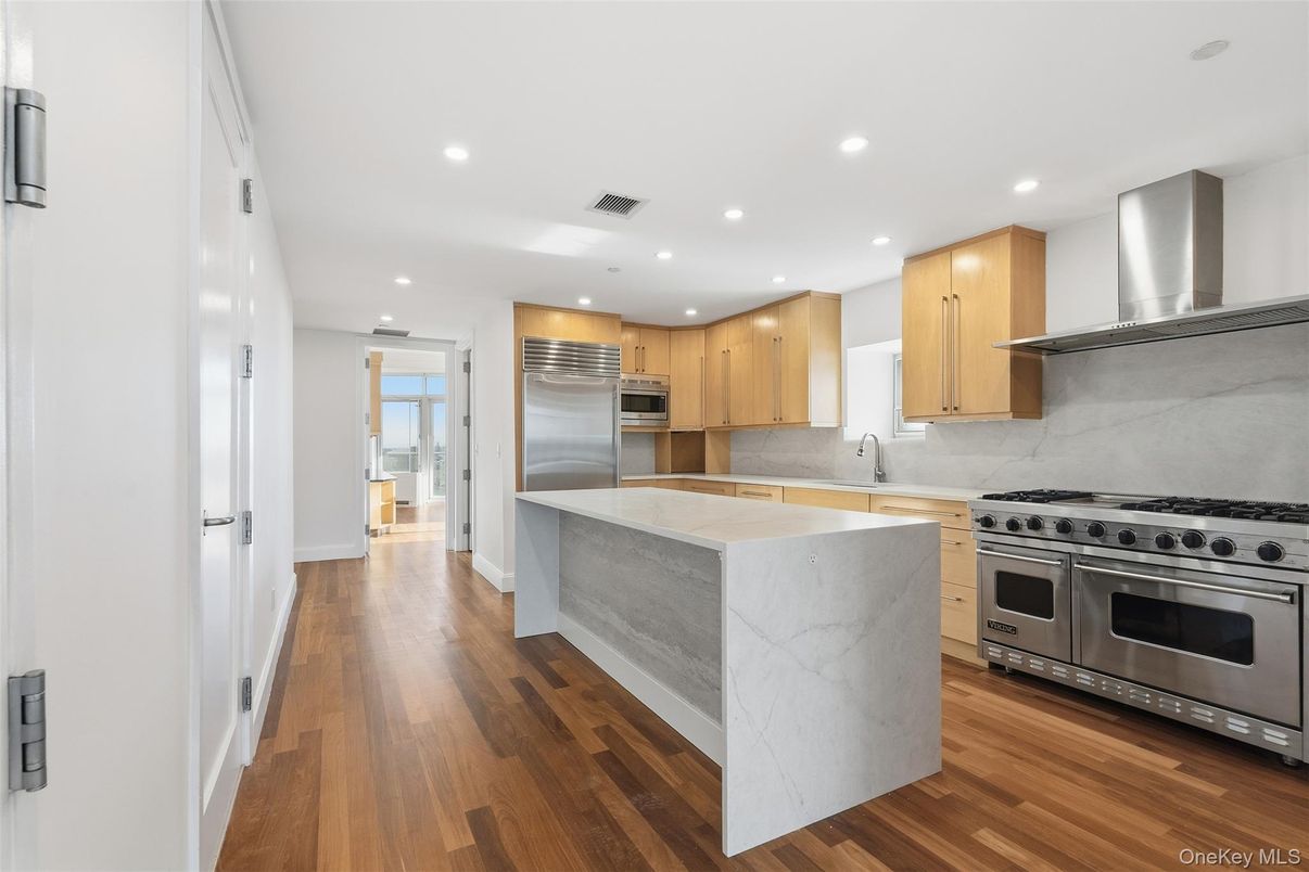 Interior, Kitchen, Marble Walls, Recessed Lighting, Stainless Steel Appliances, Wood Texture Flooring