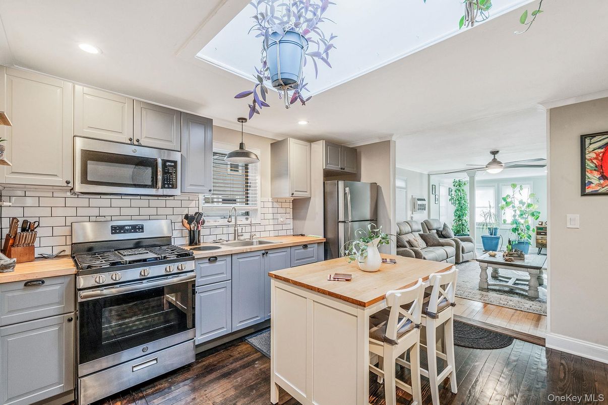 Dining room, Interior, Kitchen, Living room, Recessed Lighting, Stainless Steel Appliances, Wood Texture Flooring