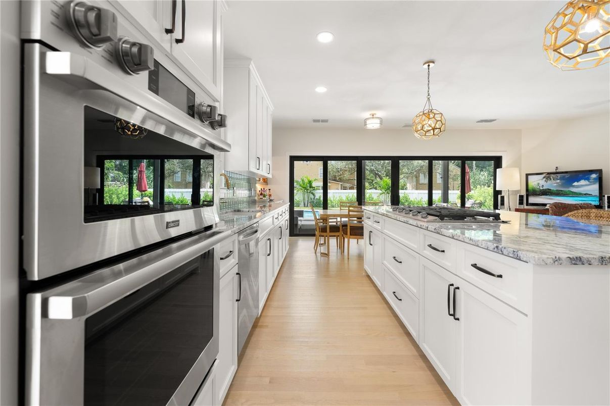 Chandelier, Dining room, Interior, Kitchen, Pendant Lights, Recessed Lighting, Stainless Steel Appliances, Wood Texture Flooring