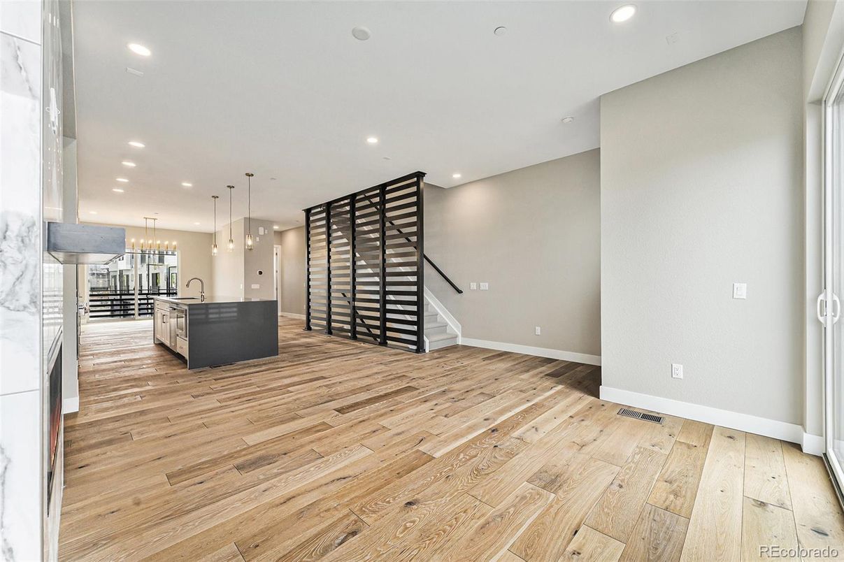 Empty room, Interior, Kitchen, Pendant Lights, Recessed Lighting, Stainless Steel Appliances, Wood Texture Flooring