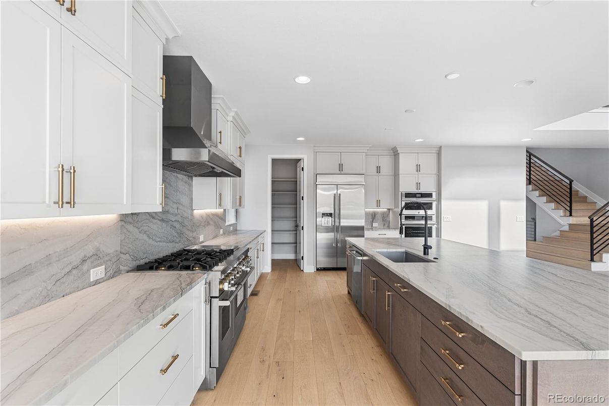 Interior, Kitchen, Marble Walls, Recessed Lighting, Stainless Steel Appliances, Wood Texture Flooring