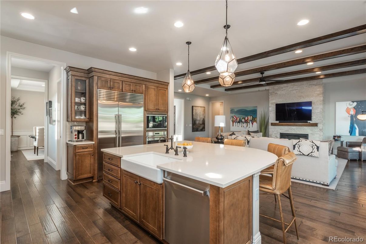 Fireplace, Interior, Kitchen, Living room, Pendant Lights, Recessed Lighting, Stainless Steel Appliances, Stone Walls, Wood Texture Flooring