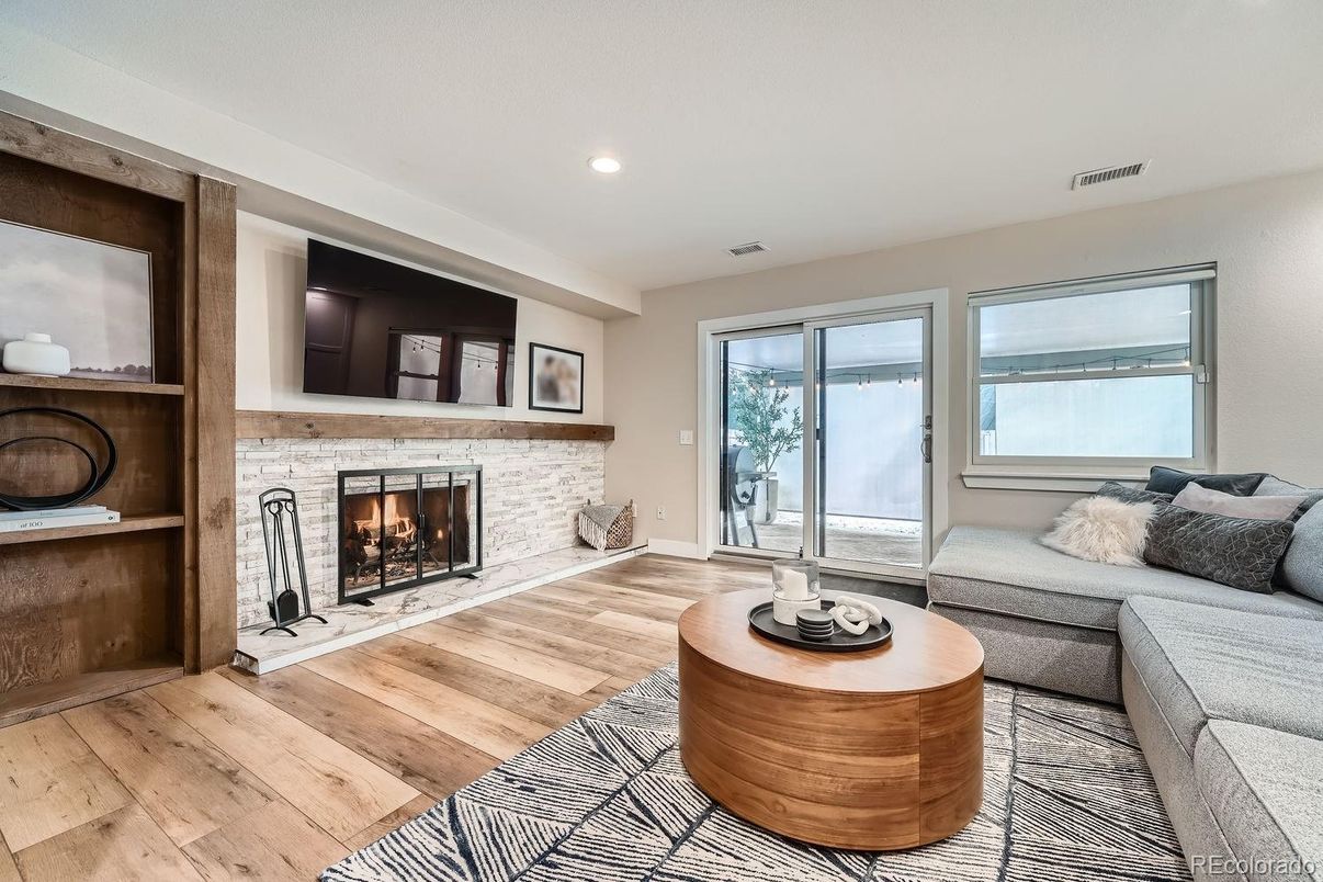Fireplace, Interior, Living room, Recessed Lighting, Stone Walls, Wood Texture Flooring